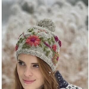 Lost Horizons Olivia hand-knit wool beanie with floral embroidery and a pom-pom